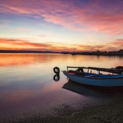 Lone fishing boat at sunrise/sunset